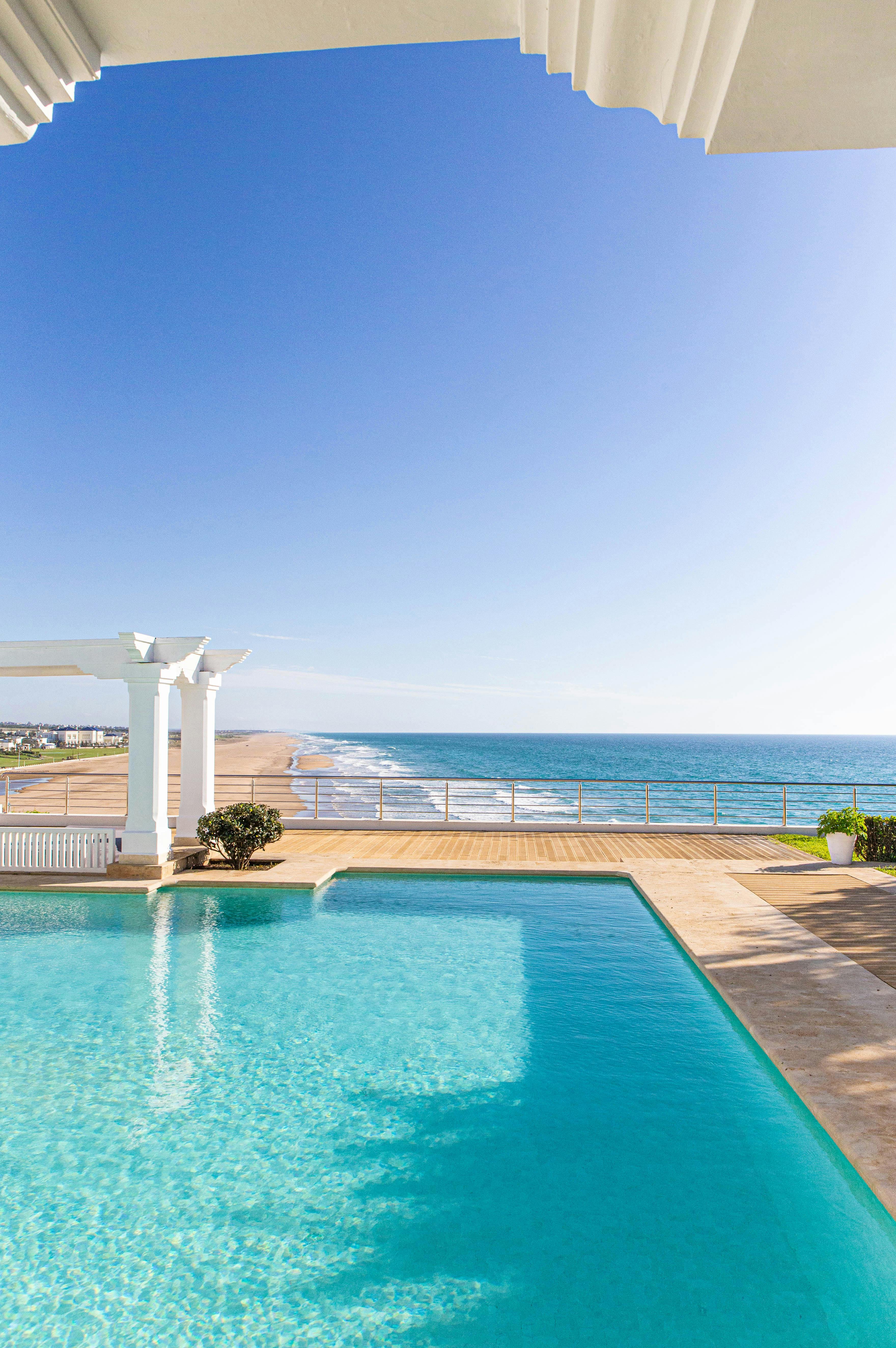 Resort-style pool with spa spillway and stone coping